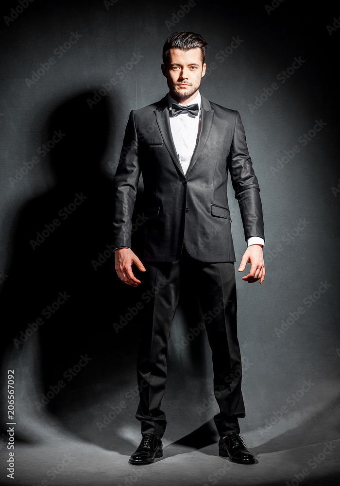 portrait of confident handsome man in black suit with bowtie portrait of confident handsome man in black suit with bowtie