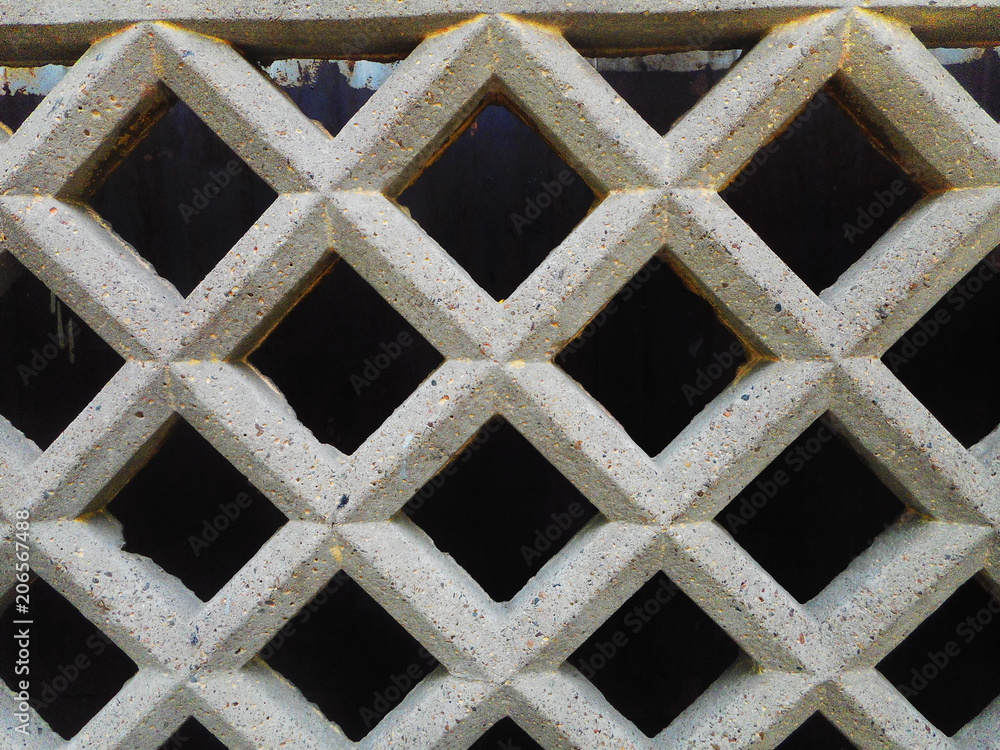diamond pattern concrete lattice fence on black background diamond pattern concrete lattice fence on black background