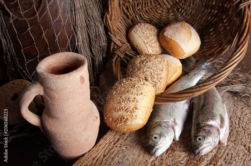 Photography Wine jug with bread and fish