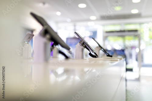 Close up of cell phones or mobile phones on display in a modern, clean and contemporary shop or mall