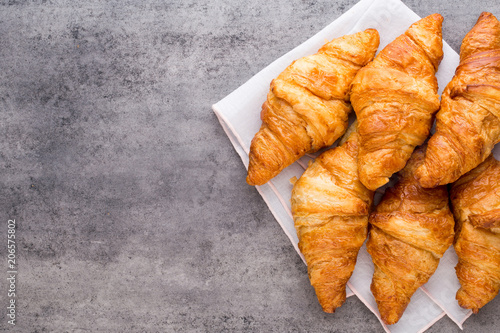 Tasty buttery croissants on old graye table.