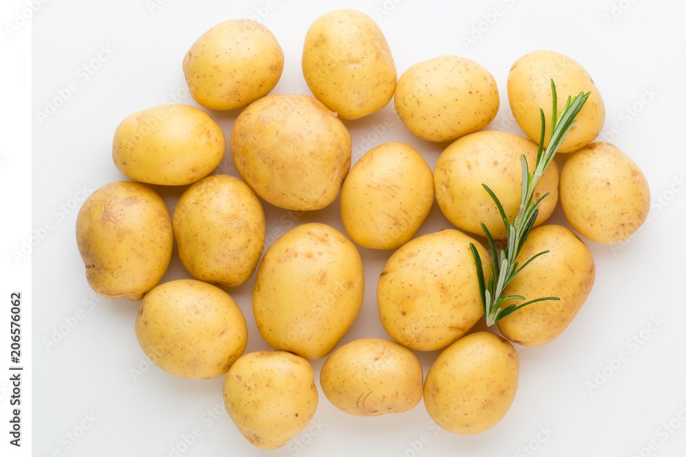 New potato and rosemarin isolated on white background close up. New potato and rosemarin isolated on white background close up.