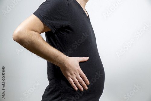 Schilderij op canvas Adult man is showing his fat, unhealty belly
