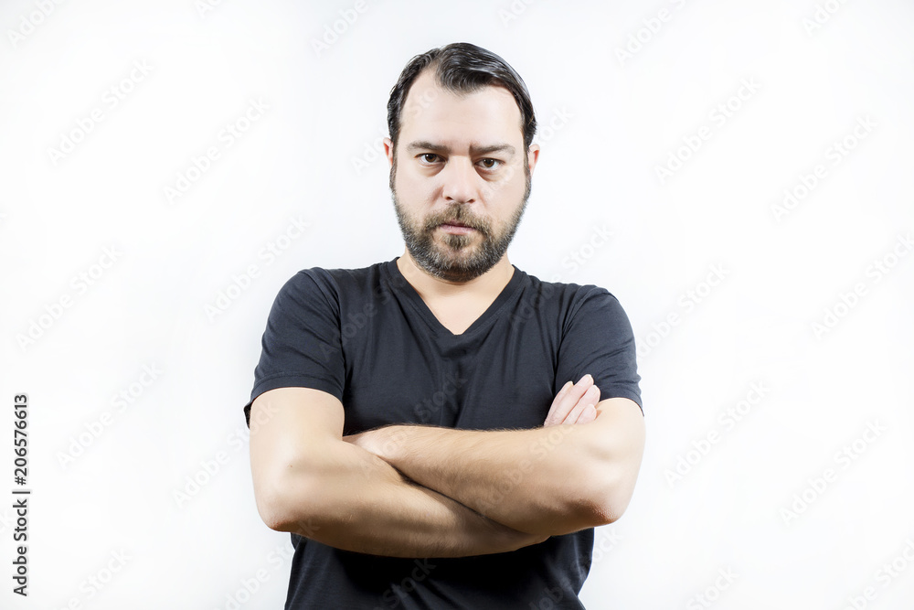 Adult man crossed arms and is looking to the camera Adult man crossed arms and is looking to the camera