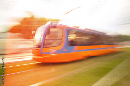 High speed passenger train in motion on railroad. A tram with motion blur effect.
