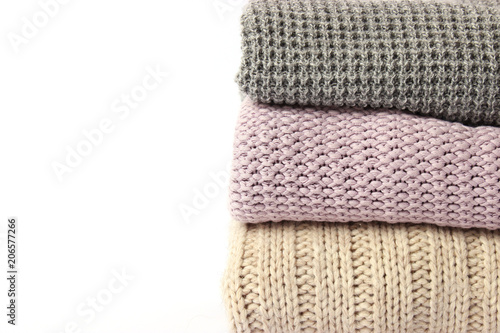 an ideal stack of warm clothes on a monophonic background. minimalism.