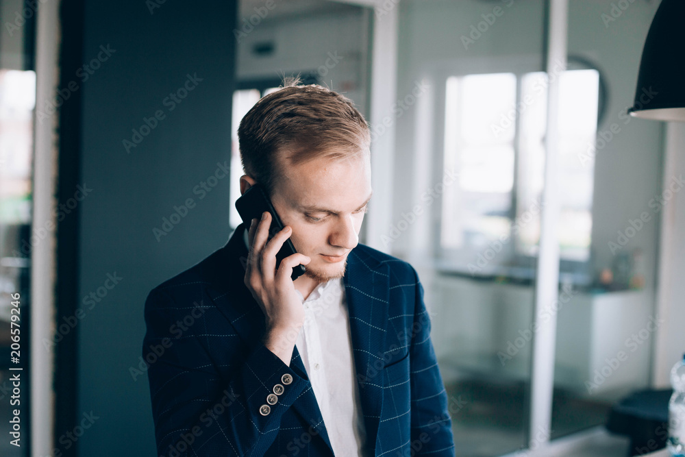young european businessman talking on mobile phone. make appointment . young european businessman talking on mobile phone. make appointment .