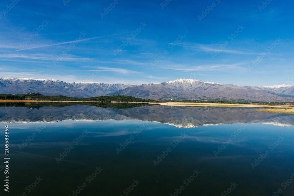 View over the lake with snowy mountains. Beautiful mountain landscape. Afternoon mountainous Spanish  scenery  