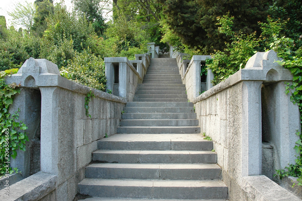 Long stone staircase leading to the distance in the old Park