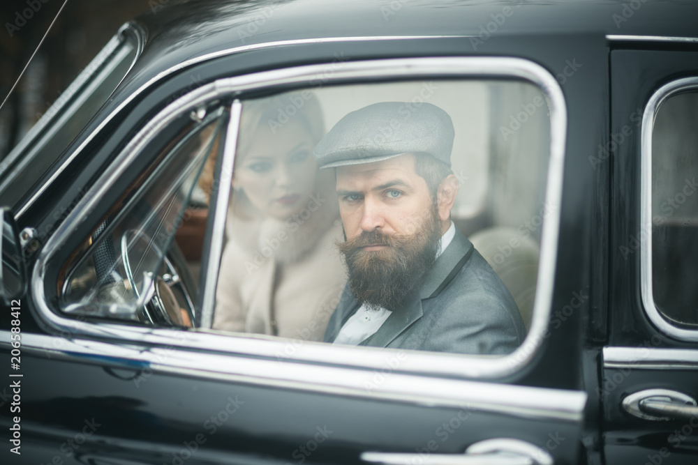 Escort of girl by security. Bearded man and sexy woman in car. Retro collection car and auto repair by mechanic driver. Travel and business trip or hitch hiking. Couple in love on romantic date.