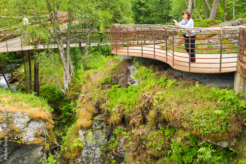 Tourist with camera on Gudbrandsjuvet viewpoint, Norway photo