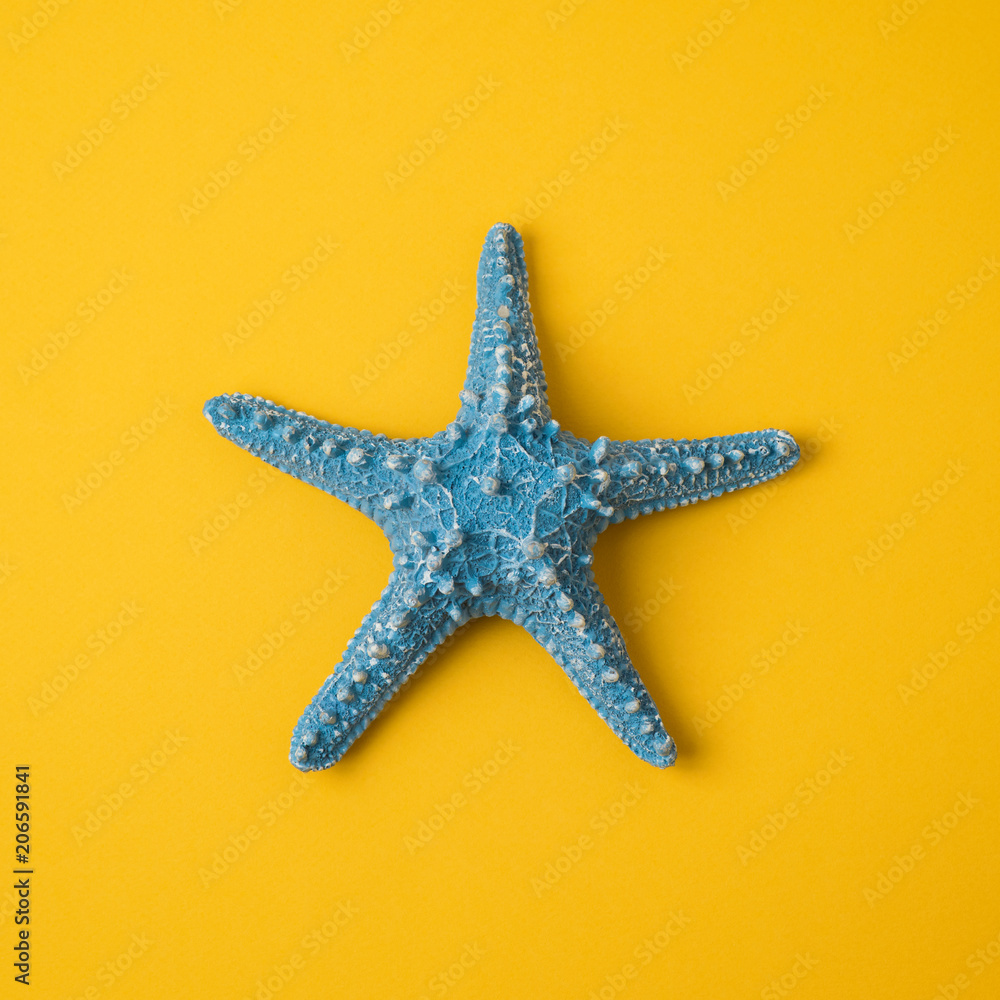 Blue starfish over yellow background Blue starfish over yellow background