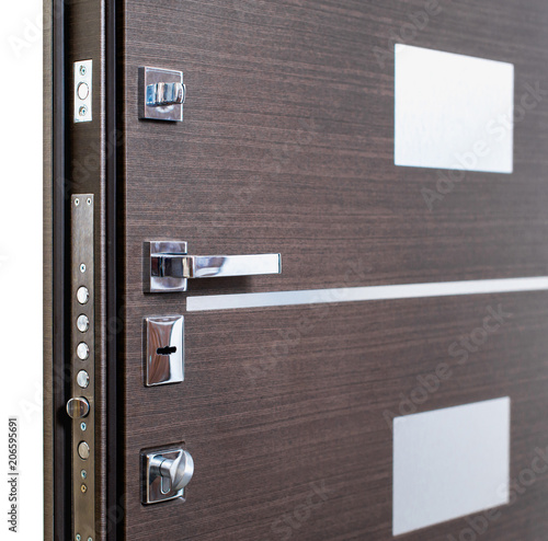Open armored door. Door lock, Dark brown door closeup. Modern interior design, door handle. New house concept. Real estate.