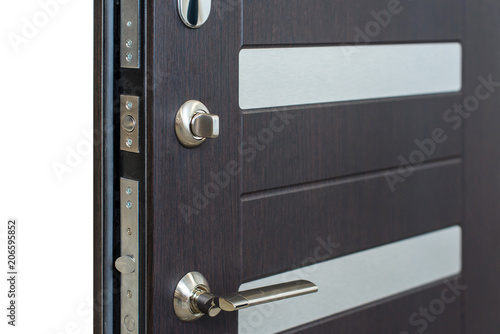 Open armored door. Door lock, Dark brown door closeup. Modern interior design, door handle. New house concept. Real estate.