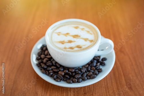 Hot coffee with art pattern in white cup