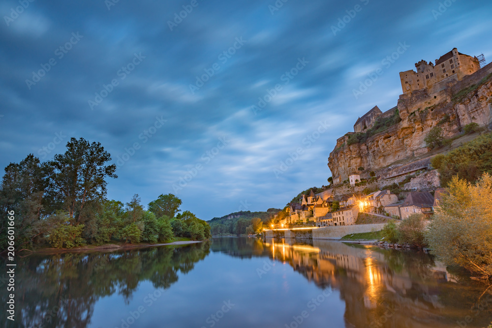 Castle and village at Beynac on the Dordogne River in France at dawn Castle and village at Beynac on the Dordogne River in France at dawn