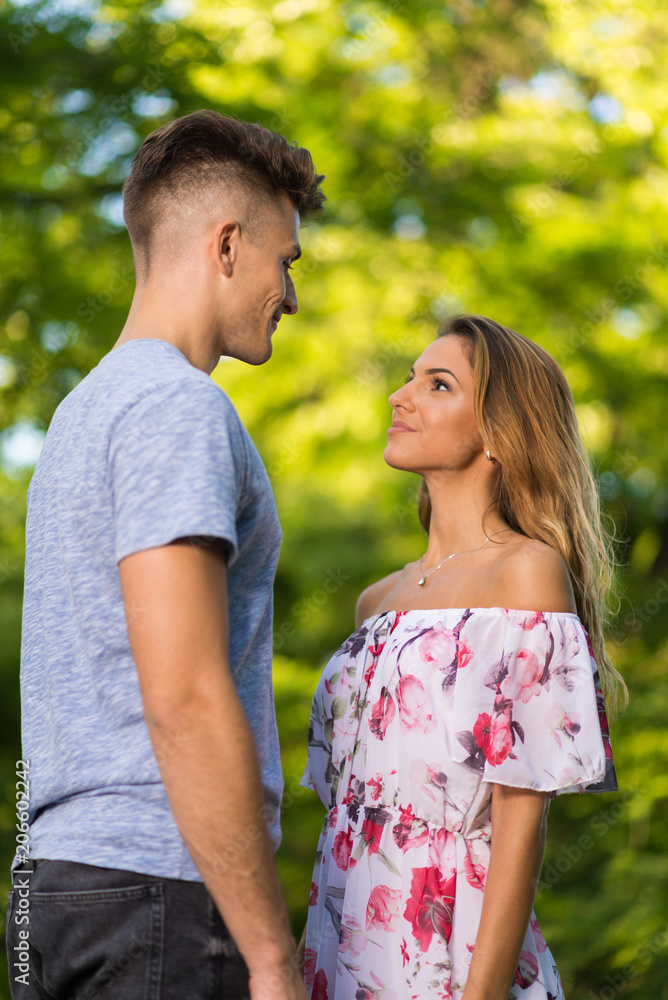 Young woman in love talking to her boyfriend in springtime at the park. Young woman in love talking to her boyfriend in springtime at the park.
