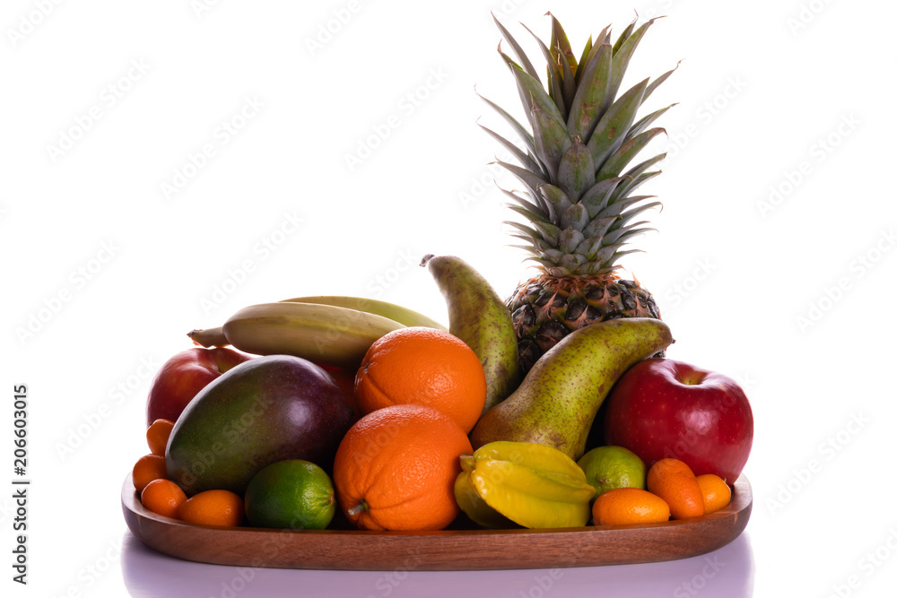Fresh fruits on an acacia wooden plate front view with reflect
