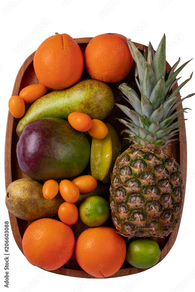 Fresh fruits on an acacia wooden plate up-view
