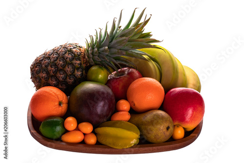 Fresh fruits on an acacia wooden plate up-view