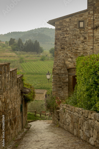 Exploring the hilltop town of Montefioralle in Tuscany, Italy with vineyards in the valley.