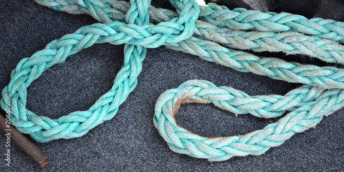 Strong blue rope on the deck of the ship. Tackles for a yacht. Rope rope for sea voyages
