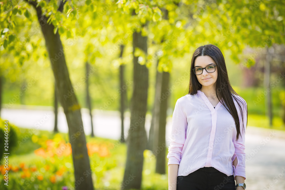 Teenager girl with glasses looking at camera and smiling Teenager girl with glasses looking at camera and smiling