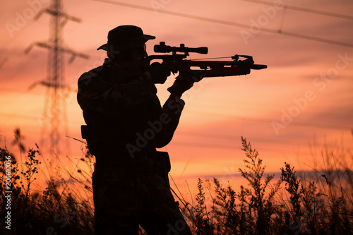 Photographie hunter with crossbow silhouette