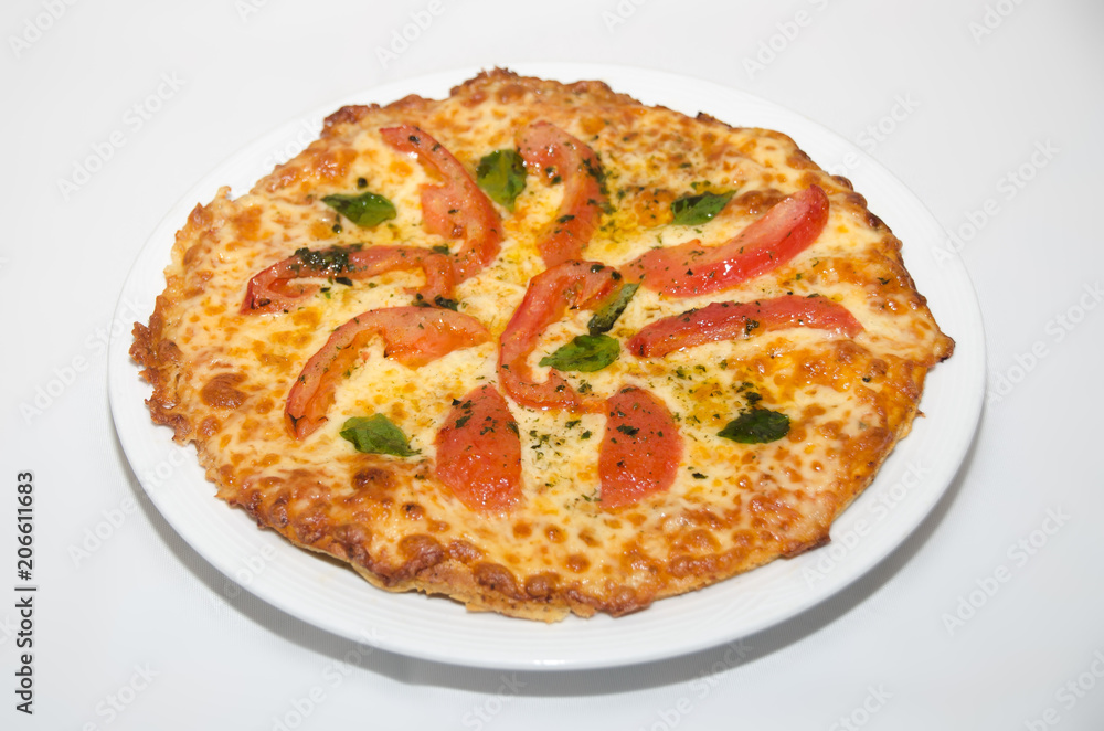 Pizza with melted cheese and tomato slices