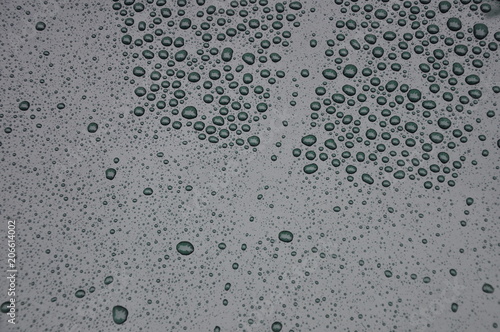  water droplets on the hood of the machine
