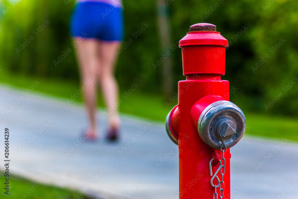 Fire hydrant in red color in the background walking girl Fire hydrant in red color in the background walking girl
