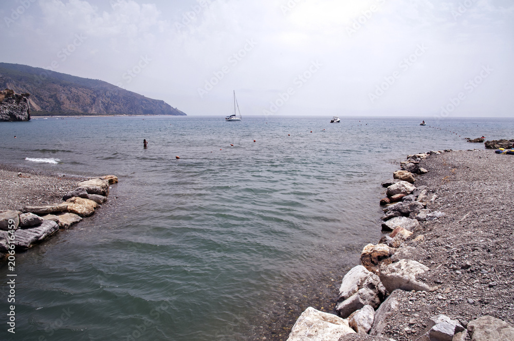 Bay where the river flows into with boats and people taking a bath Bay where the river flows into with boats and people taking a bath