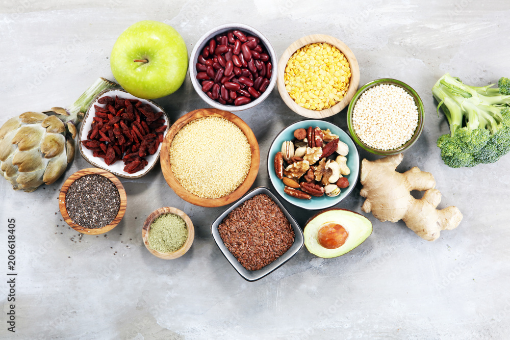 superfood concept on stone table with avocado, goji and nuts and seeds. superfood concept on stone table with avocado, goji and nuts and seeds.