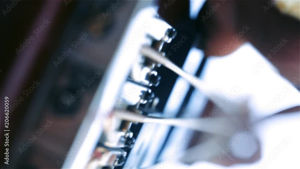 Bassist Hand Playing the Bass Guitar in Concert. Close-Up. Bassist Hand Playing the Bass Guitar in Concert. Close-Up.