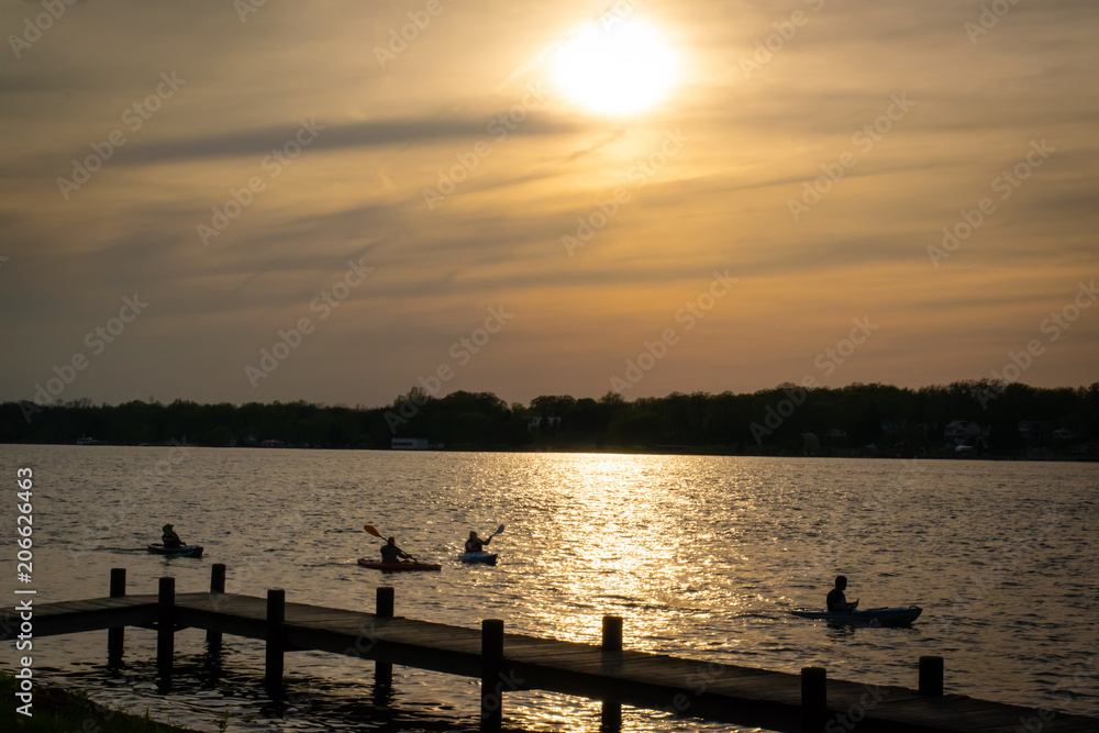 People kayaking on a spring evening with sunset on the Niagara River near Buffalo, N.Y.