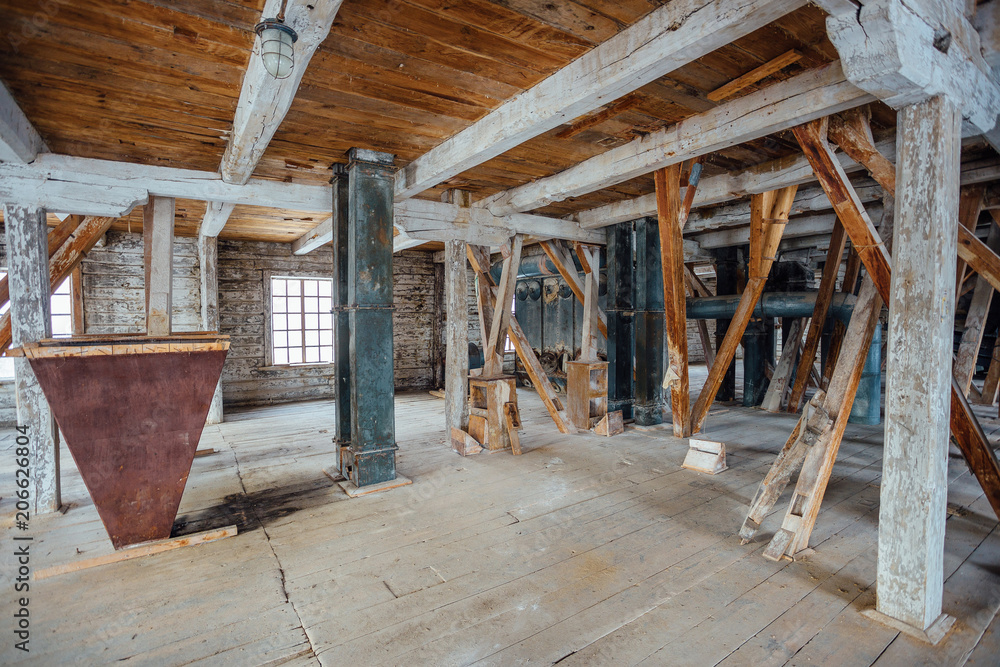 Inside old abandoned wooden mill with old equipment Inside old abandoned wooden mill with old equipment