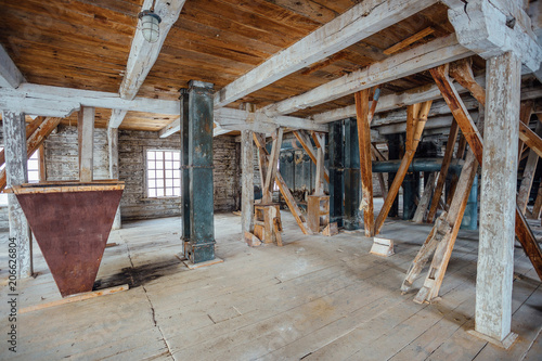 Inside old abandoned wooden mill with old equipment