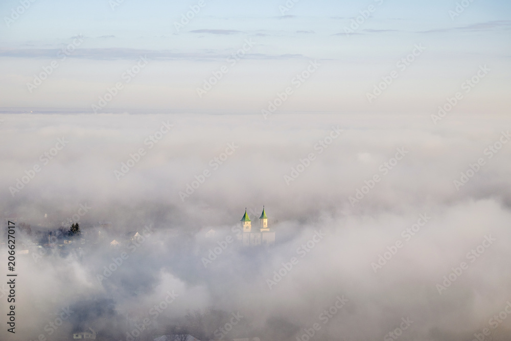Fototapeta premium Church in fog from above