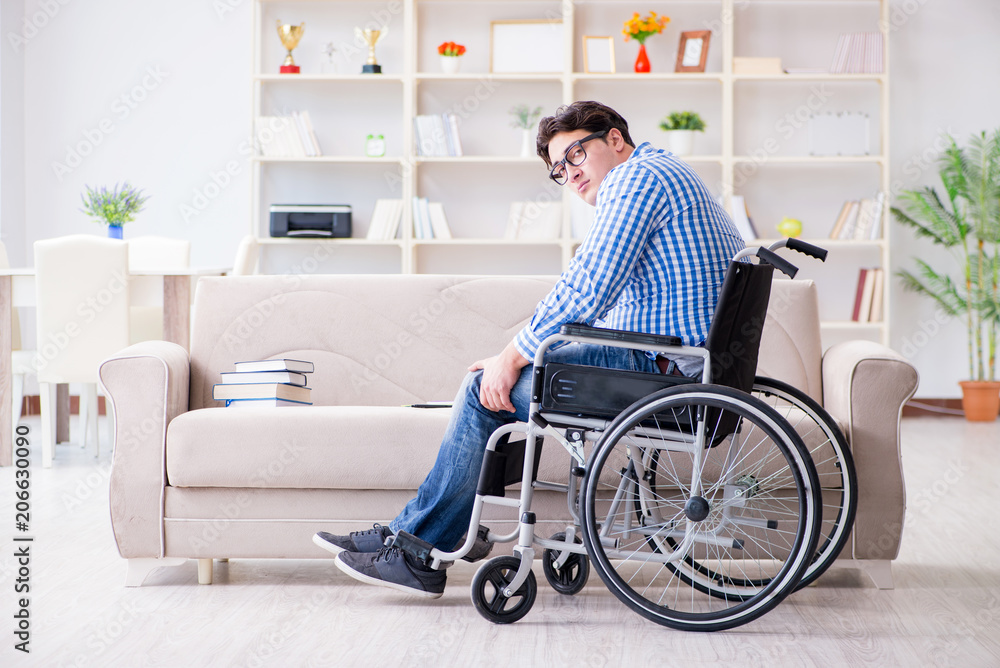 Young student on wheelchair in disability concept Young student on wheelchair in disability concept
