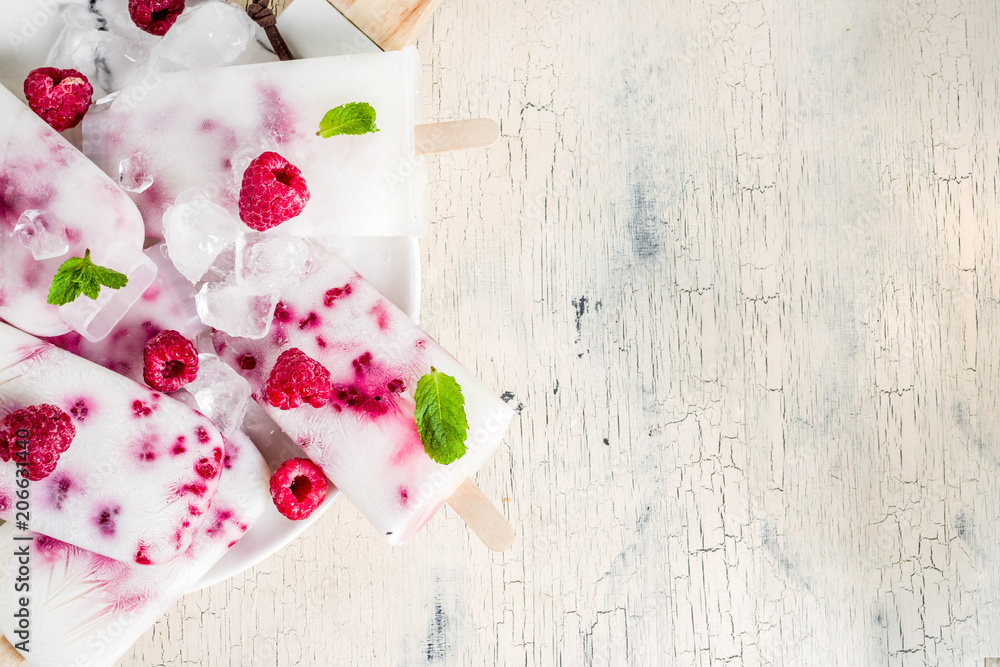 Summer sweet desserts, homemade organic ice cream popsicles from raspberry and yogurt, light beige background copy space Summer sweet desserts, homemade organic ice cream popsicles from raspberry and yogurt, light beige background copy space