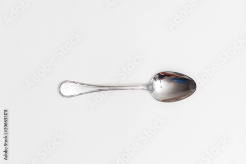 Single spoon on a white background in a studio