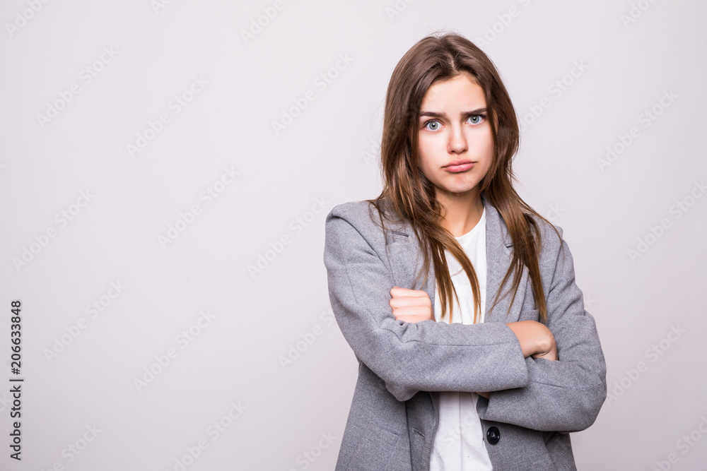 Portrait of an angry serious woman with folded arms isolated on a white background Portrait of an angry serious woman with folded arms isolated on a white background
