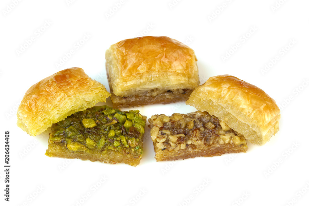 Delicious Turkish baklava with green pistachio nuts  and walnuts isolated on white background.
