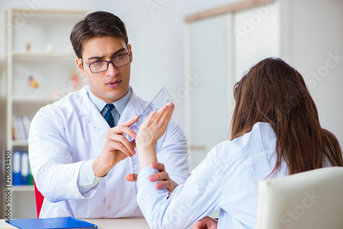 Doctor checking patients joint flexibility with gonimeter