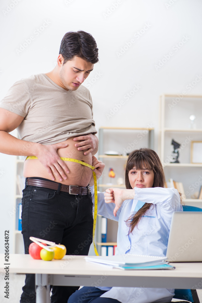 Doctor dietician giving advices to fat overweight patient Doctor dietician giving advices to fat overweight patient