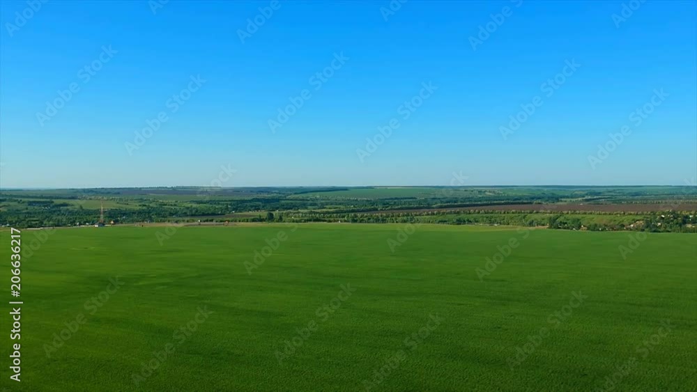 boundless green rice field against distant village by pictorial hills. boundless green rice field against distant village by pictorial hills.