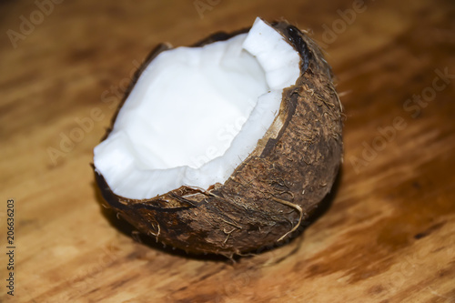 Cracked coconut on a wooden background