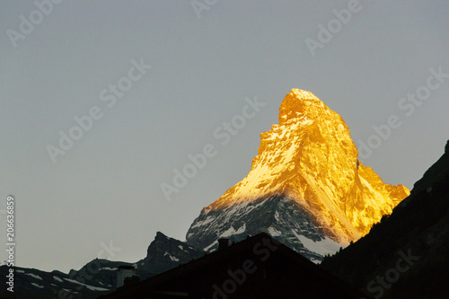 The gold top of the Matterhorn in Zermatt Swiss.