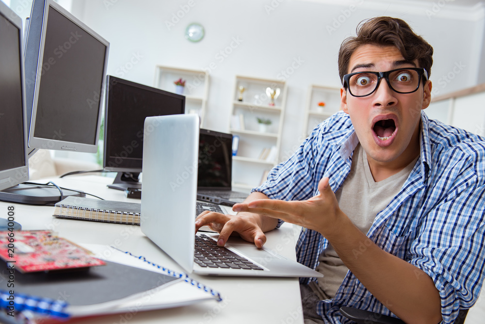 Businessman sitting in front of many screens Businessman sitting in front of many screens