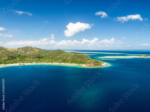 Aerial Landscape View of Tropical South Pacific Island Resort Surrounded by White Sand Beach, Ocean and Reef in Fiji
